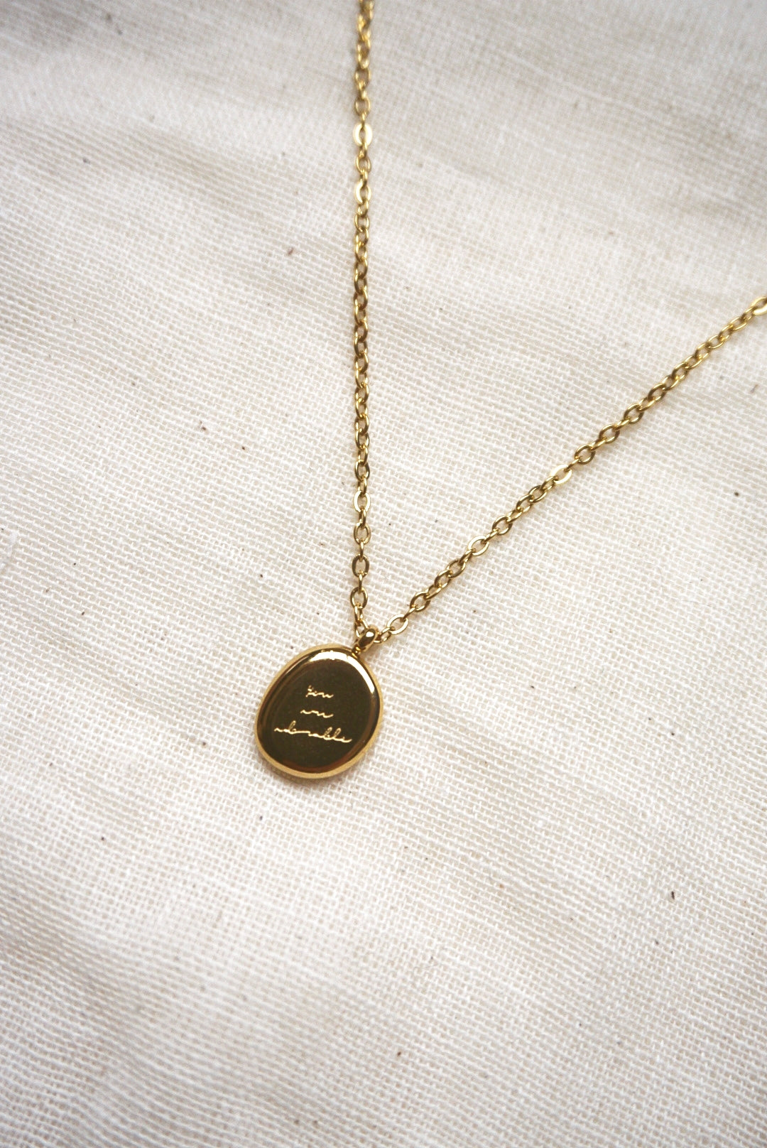 Gold engraved store pendant